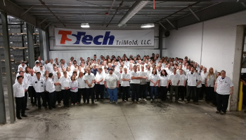 TriMold, LLC staff standing together in factory